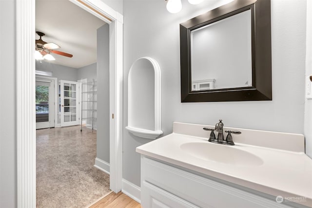 bathroom with vanity, hardwood / wood-style flooring, and ceiling fan