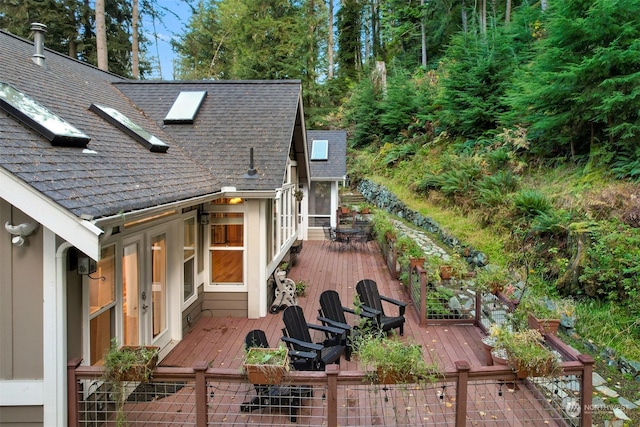 rear view of house featuring a wooden deck