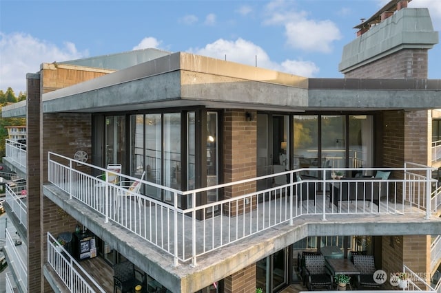 rear view of property with a balcony