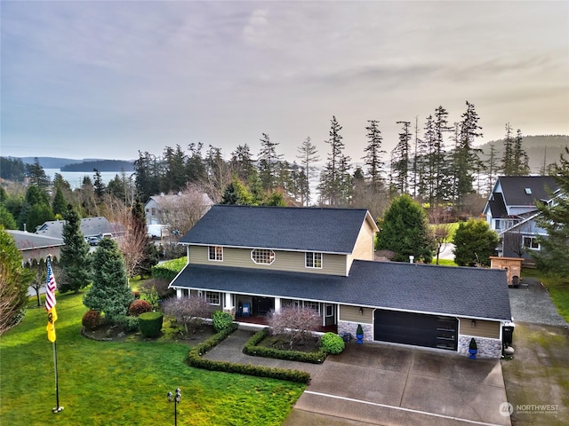 view of front of property featuring a garage and a yard