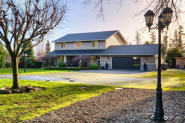 view of front of property featuring a front yard and a garage