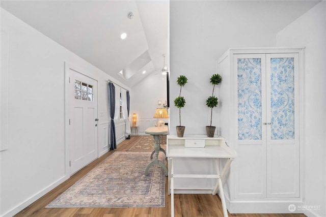 foyer entrance featuring hardwood / wood-style floors and lofted ceiling