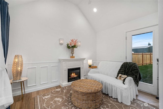 sitting room featuring wood-type flooring and lofted ceiling