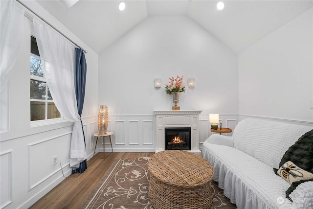 living area with dark hardwood / wood-style flooring and vaulted ceiling