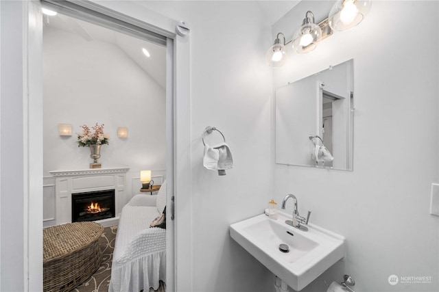 bathroom featuring sink and vaulted ceiling