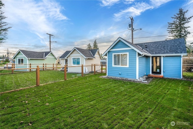 back of house featuring a lawn