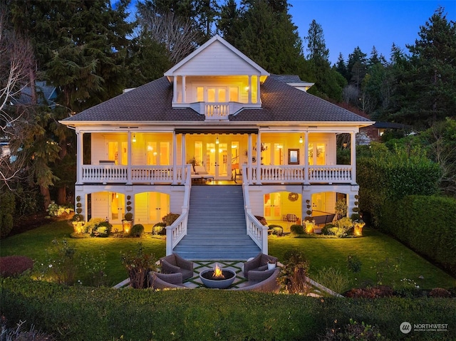 view of front of property featuring a balcony and a front yard