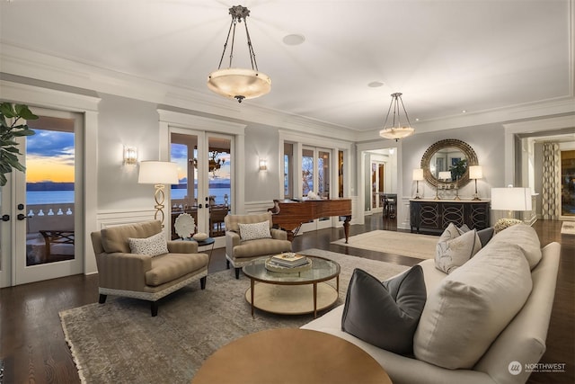 living room with crown molding, french doors, dark hardwood / wood-style floors, and a water view