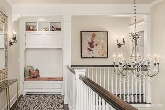 corridor featuring an inviting chandelier and ornamental molding