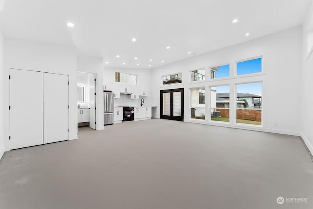 unfurnished living room featuring sink