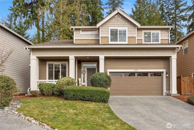 craftsman-style house featuring driveway, a front lawn, and an attached garage