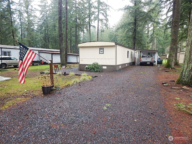 view of side of property with a carport