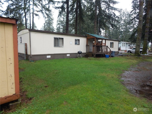 rear view of house with a yard