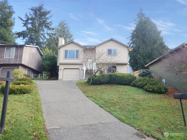 view of front of home with a garage and a front lawn