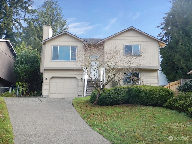 view of front of property with a front yard and a garage