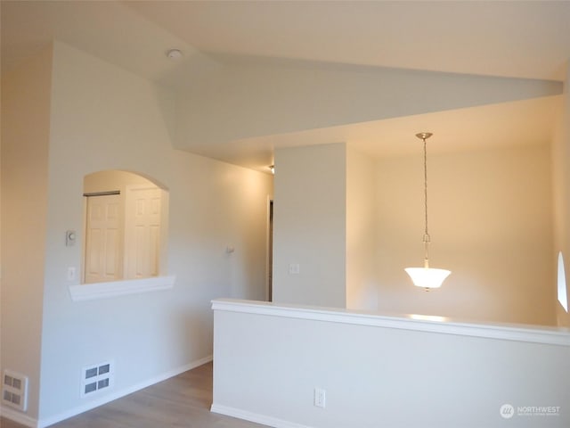 empty room featuring hardwood / wood-style floors and lofted ceiling