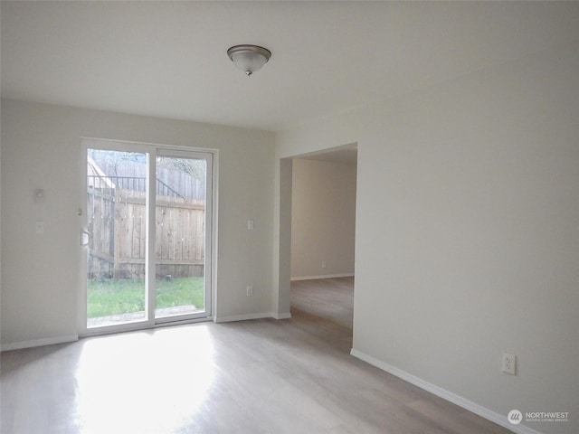 unfurnished room with light hardwood / wood-style floors