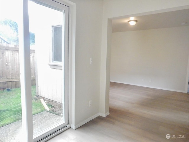 unfurnished room with light wood-type flooring