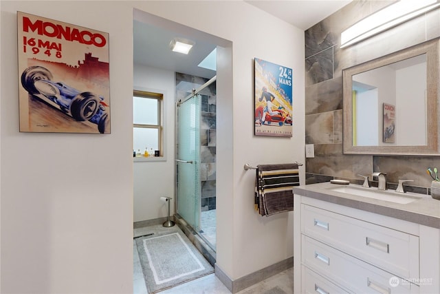 bathroom with a shower with door and vanity