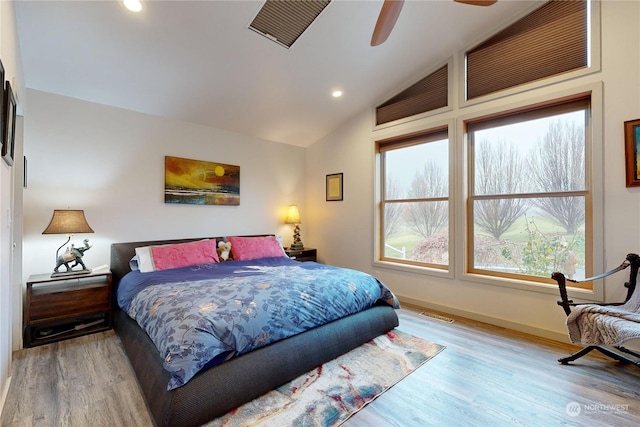 bedroom featuring ceiling fan, lofted ceiling, and light hardwood / wood-style floors