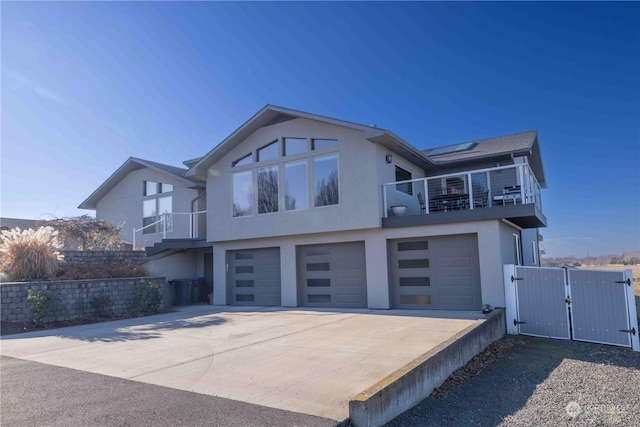 view of front of home featuring a garage, a balcony, and solar panels