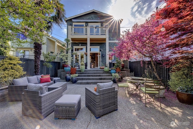 2031 42nd Ave E, Seattle, WA 98112 - rear view of property featuring outdoor lounge area, a fenced backyard, a balcony, and a patio area