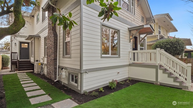 view of side of home featuring a lawn