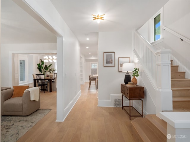 hall with light hardwood / wood-style flooring and plenty of natural light