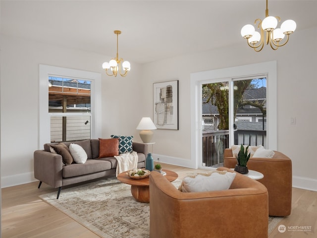 living room featuring light wood-type flooring and an inviting chandelier