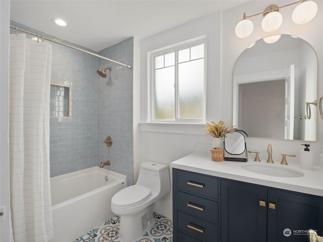 full bathroom featuring toilet, vanity, tile patterned flooring, and shower / tub combo with curtain