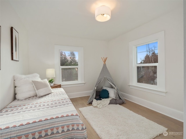 bedroom with hardwood / wood-style flooring