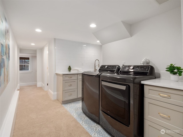 kitchen with washer and dryer, light carpet, and gray cabinets