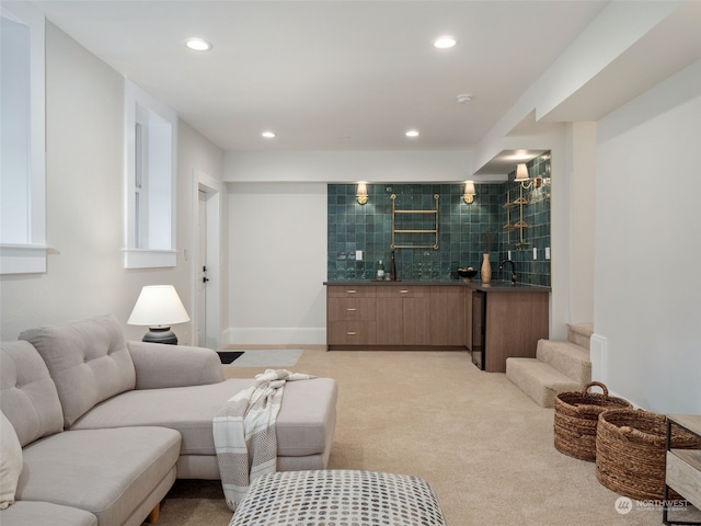 living room with wet bar and light colored carpet