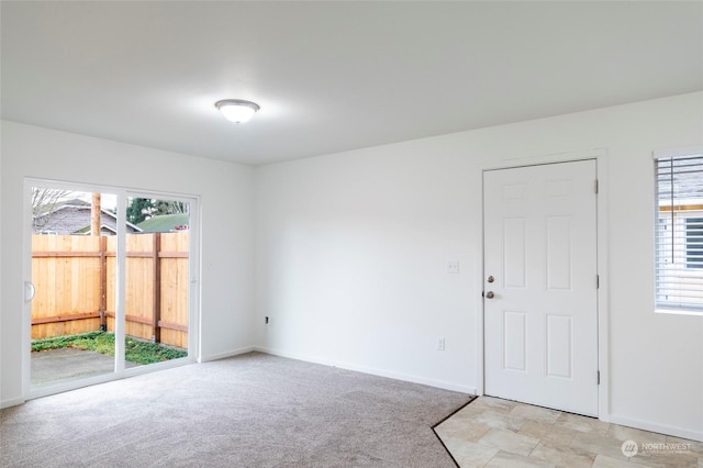 empty room featuring light colored carpet