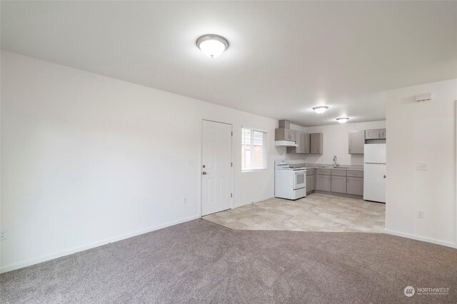 243 23rd Ave Unit 1-9, Longview, WA 98632 - kitchen featuring white appliances, gray cabinetry, light colored carpet, light countertops, and open floor plan