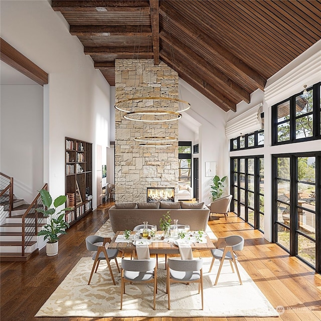 dining space featuring hardwood / wood-style flooring, high vaulted ceiling, and beamed ceiling