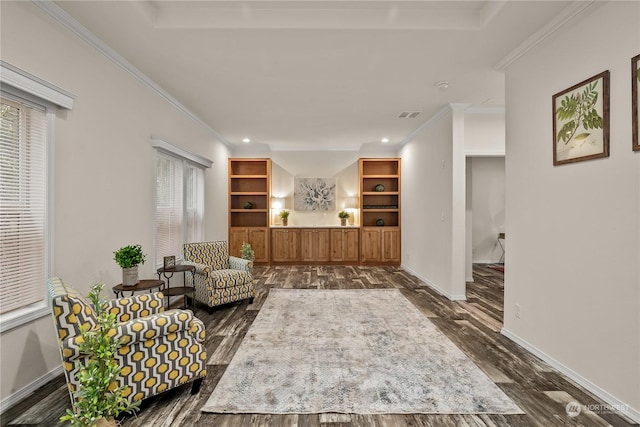 sitting room with crown molding, plenty of natural light, and dark wood-type flooring