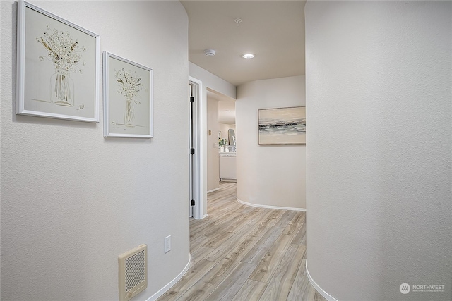 hall with light wood-type flooring