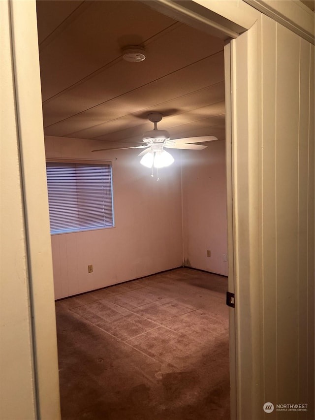 empty room with carpet floors and ceiling fan