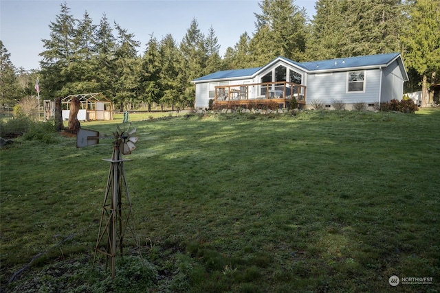 view of yard featuring a shed and a wooden deck