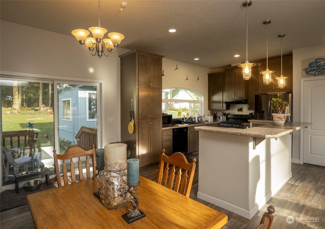 dining room with dark hardwood / wood-style floors, sink, and an inviting chandelier