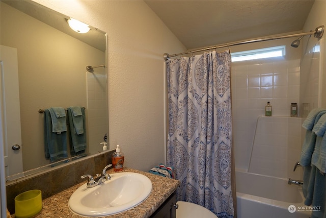 full bathroom with vanity, toilet, shower / bathtub combination with curtain, and lofted ceiling