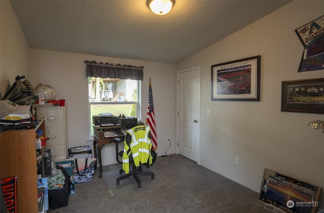 carpeted home office featuring vaulted ceiling