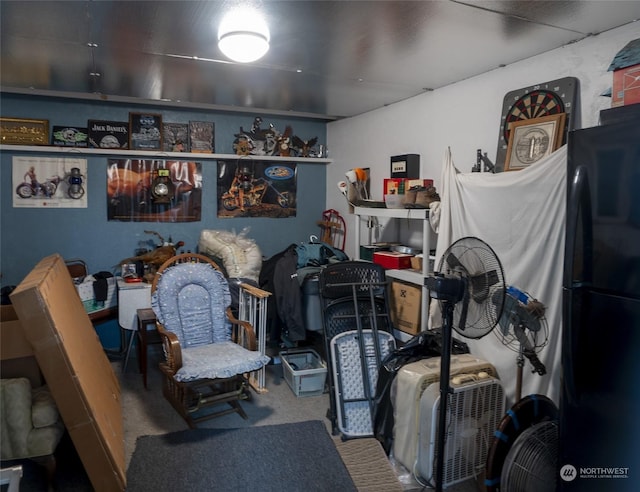 carpeted bedroom with black fridge