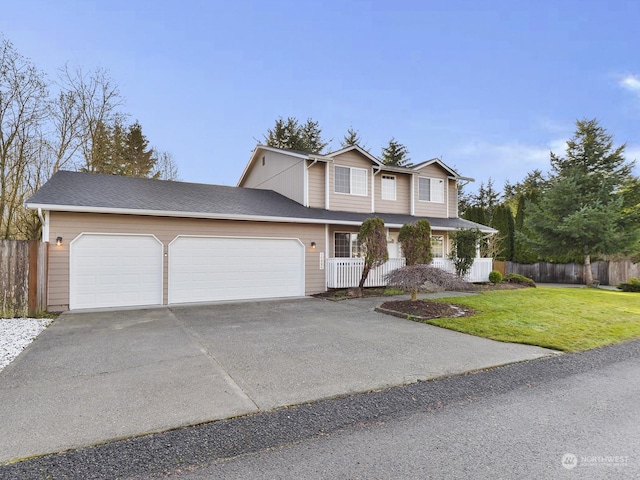 view of property featuring a porch, a garage, and a front yard