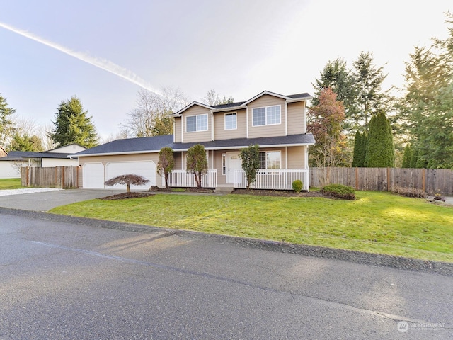 view of front of home with a front yard, a porch, and a garage