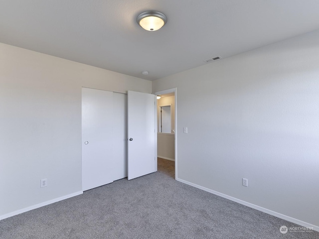 unfurnished bedroom featuring carpet floors and a closet