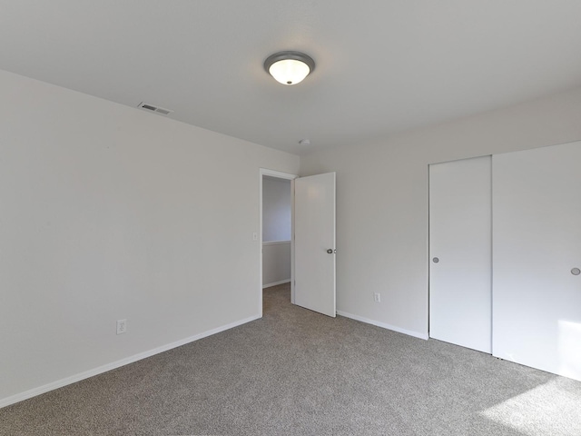 unfurnished bedroom with a closet and carpet