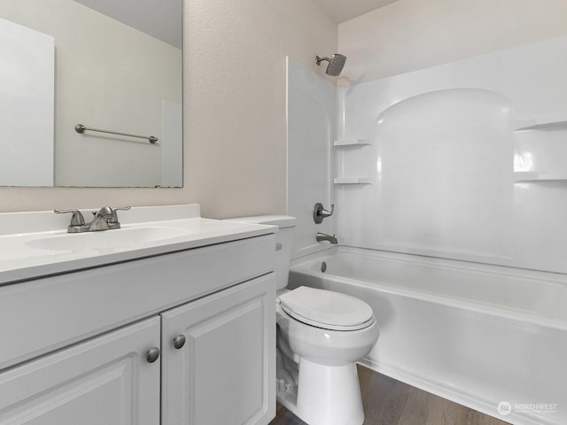 full bathroom featuring shower / tub combination, vanity, wood-type flooring, and toilet