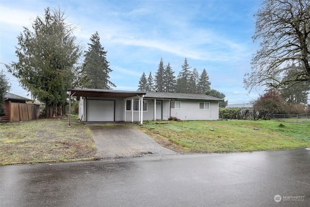 view of front facade with a carport, a garage, and a front yard